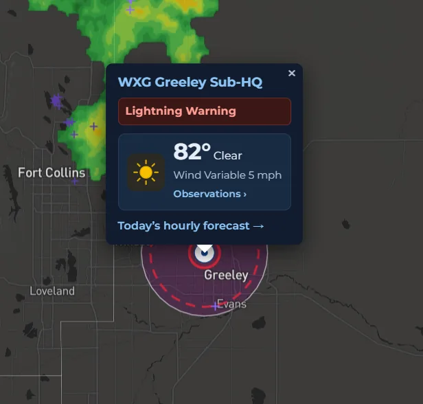 SiteWarn portal map in dark mode: a site's popup showing an active lightning warning, current temperature and wind, with the lightning warning radius drawn around the site